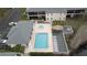 Aerial shot of community pool with a hot tub, lounge chairs and landscaping at 13140 Village Chase Cir # 13140, Tampa, FL 33618