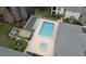 Aerial view of a community pool with a spa, lounge chairs, and outdoor seating at 13140 Village Chase Cir # 13140, Tampa, FL 33618
