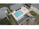 Overhead view of community pool, hot tub, with lounge chairs and dining area at 13140 Village Chase Cir # 13140, Tampa, FL 33618