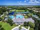 Aerial view of resort-style amenities, including a pool, tennis courts, and clubhouse, in lush surroundings at 14841 Tudor Chase Dr, Tampa, FL 33626