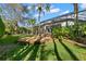 A spacious backyard offers lush greenery, mature trees, and the perfect space for outdoor activities and relaxation at 14841 Tudor Chase Dr, Tampa, FL 33626