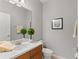 A well-lit bathroom showcases a wood vanity, white countertops, and decorative accents, a fresh modern space at 14841 Tudor Chase Dr, Tampa, FL 33626