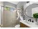 Well-lit bathroom featuring tile-surround shower, and vanity with sink and mirror at 14841 Tudor Chase Dr, Tampa, FL 33626