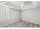 An empty bedroom with a fan, and a window with light-filtering shutters at 14841 Tudor Chase Dr, Tampa, FL 33626