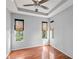 This bedroom features hardwood floors, natural light, and a modern ceiling fan at 14841 Tudor Chase Dr, Tampa, FL 33626