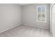 Empty bedroom with a window with light-filtering shutters and carpeted floor at 14841 Tudor Chase Dr, Tampa, FL 33626