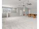 Spacious carpeted bonus room featuring ceiling fans, neutral paint, and ample natural light, a versatile living space at 14841 Tudor Chase Dr, Tampa, FL 33626