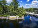 Scenic aerial view of a community entrance with lush landscaping and a picturesque bridge at 14841 Tudor Chase Dr, Tampa, FL 33626