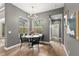 Bright dining area with modern chandelier, view to the pool and a marble top table at 14841 Tudor Chase Dr, Tampa, FL 33626