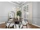 Dining room showcasing large windows, tray ceiling, and stylish decor at 14841 Tudor Chase Dr, Tampa, FL 33626