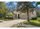 Charming home featuring a two-car garage, manicured lawn, and mature landscaping for enhanced curb appeal at 14841 Tudor Chase Dr, Tampa, FL 33626