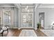 Bright foyer featuring elegant double doors, tray ceiling, and modern pendant lighting at 14841 Tudor Chase Dr, Tampa, FL 33626