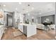 Open concept kitchen with stainless steel appliances, center island and view to the living room at 14841 Tudor Chase Dr, Tampa, FL 33626