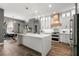 Bright kitchen with white cabinets, stainless appliances, quartz countertops, and pendant lighting at 14841 Tudor Chase Dr, Tampa, FL 33626