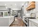 Beautiful kitchen boasts stainless steel appliances, white cabinets, quartz countertops, a stove and oven at 14841 Tudor Chase Dr, Tampa, FL 33626