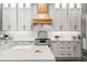 Close up of updated kitchen with custom cabinets, quartz countertops and high-end stainless steel appliances at 14841 Tudor Chase Dr, Tampa, FL 33626