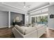 Comfortable living room with modern decor, hardwood floors, and views of the outdoor pool at 14841 Tudor Chase Dr, Tampa, FL 33626