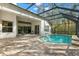 Enjoy a large covered and screened lanai with brick pavers and an inviting outdoor space by the pool at 14841 Tudor Chase Dr, Tampa, FL 33626