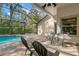Screened-in pool area offers a relaxing space, complete with brick pavers, outdoor seating, and lush landscaping at 14841 Tudor Chase Dr, Tampa, FL 33626