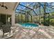 Screened-in pool with brick paved deck, lounge seating, and private backyard view at 14841 Tudor Chase Dr, Tampa, FL 33626