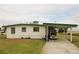 The carport provides sheltered parking, adding convenience to this compact single-story home at 1510 Council Dr, Sun City Center, FL 33573