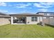 Backyard boasts a covered patio, well-manicured lawn, and privacy fence, offering a serene outdoor space at 20778 Balsam Hill Rd, Land O Lakes, FL 34638