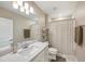 Bathroom features a single sink vanity, large mirror, modern lighting, and shower with shower curtain at 20778 Balsam Hill Rd, Land O Lakes, FL 34638