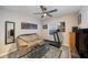 Cozy bedroom with comfortable seating, a ceiling fan, and a treadmill, perfect for relaxation and exercise at 20778 Balsam Hill Rd, Land O Lakes, FL 34638