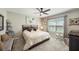 Comfortable bedroom featuring plush carpet, neutral decor, and a large window providing ample natural light at 20778 Balsam Hill Rd, Land O Lakes, FL 34638