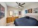 This cozy bedroom has unique decor, a ceiling fan, and a large dresser, creating a personalized space at 20778 Balsam Hill Rd, Land O Lakes, FL 34638