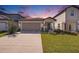 Charming two-story home featuring a well-maintained lawn, neutral color scheme, and attached two-car garage at 20778 Balsam Hill Rd, Land O Lakes, FL 34638
