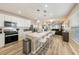 Bright, open kitchen with white cabinetry, stainless steel appliances, and an island with seating at 20778 Balsam Hill Rd, Land O Lakes, FL 34638