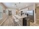 Modern open-concept kitchen with large island, stainless steel appliances, and eat-in bar at 20778 Balsam Hill Rd, Land O Lakes, FL 34638