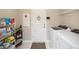 Functional laundry room with modern washer and dryer, storage shelves, and neutral walls for a clean look at 20778 Balsam Hill Rd, Land O Lakes, FL 34638