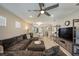 Inviting living room with hardwood floors, a plush sectional, and an open layout at 20778 Balsam Hill Rd, Land O Lakes, FL 34638