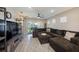 Comfortable living room with hardwood floors, a sectional sofa, and an open layout at 20778 Balsam Hill Rd, Land O Lakes, FL 34638