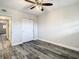 Bright bedroom boasts sleek wood-look floors and a contemporary ceiling fan at 2253 Norwegian Dr # 67, Clearwater, FL 33763