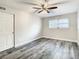 Spacious bedroom featuring wood-look floors and a bright window at 2253 Norwegian Dr # 67, Clearwater, FL 33763