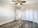 Bedroom features ceiling fan, wood floors, an open doorway, and double closets at 2253 Norwegian Dr # 67, Clearwater, FL 33763