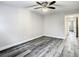 This bedroom features wood-look floors and a contemporary ceiling fan at 2253 Norwegian Dr # 67, Clearwater, FL 33763