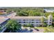 Exterior showing the building's balconies and well-manicured grounds and ample parking at 2253 Norwegian Dr # 67, Clearwater, FL 33763