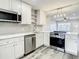 Updated kitchen featuring stainless steel appliances, hexagon tile backsplash, and bright lighting at 2253 Norwegian Dr # 67, Clearwater, FL 33763