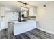 Modern kitchen features white cabinetry, quartz countertops, stainless appliances, and wood floors at 2253 Norwegian Dr # 67, Clearwater, FL 33763