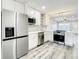 Beautiful modern kitchen boasts stainless steel appliances, white cabinets, and stylish wood floors at 2253 Norwegian Dr # 67, Clearwater, FL 33763