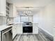 Open kitchen with white countertops, stainless steel oven, and view to the front door at 2253 Norwegian Dr # 67, Clearwater, FL 33763