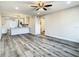 Open living area transitions into a bright kitchen featuring wood floors and modern design at 2253 Norwegian Dr # 67, Clearwater, FL 33763
