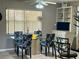 Bright dining area with a glass table, four chairs, and a built-in cabinet at 22941 Leafwood Ct, Land O Lakes, FL 34639