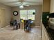 Cozy dining area featuring a glass-top table with four chairs and natural lighting at 22941 Leafwood Ct, Land O Lakes, FL 34639