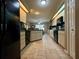 Functional kitchen equipped with black appliances, ample counter space, and tiled flooring at 22941 Leafwood Ct, Land O Lakes, FL 34639