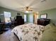 Spacious main bedroom features a ceiling fan, wood-look floors, and dual dressers at 22941 Leafwood Ct, Land O Lakes, FL 34639
